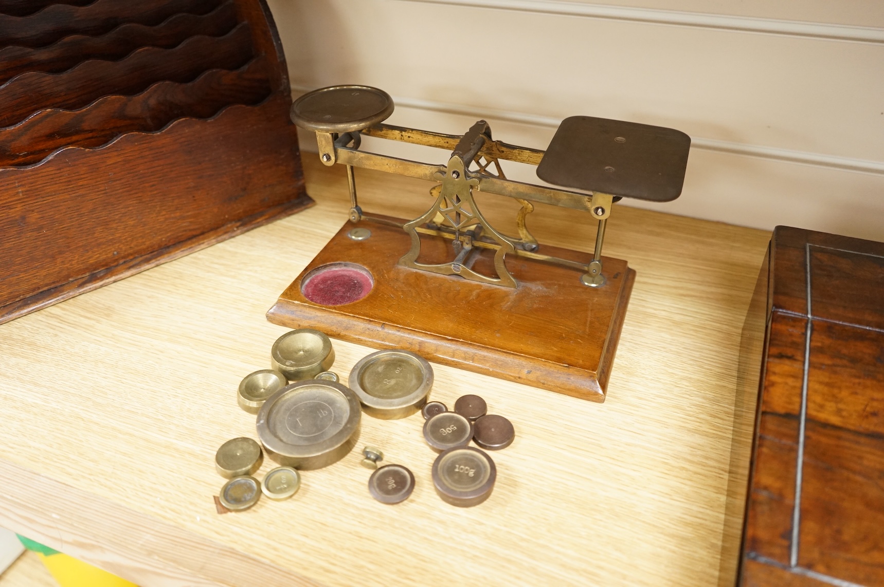 A tooled leather writing slope, a letter rack and postage scales, largest 37cm wide